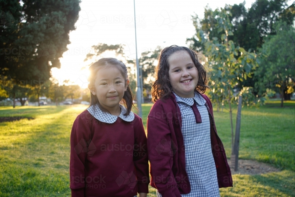 Image of Two happy school girls in the playground after school ...