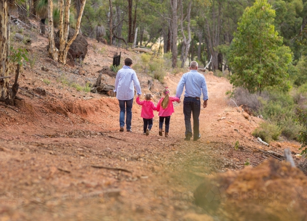 Two little girls and their parents outdoors - Australian Stock Image