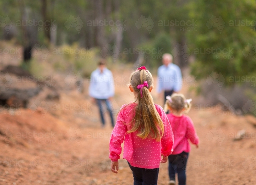 Two little girls and their parents outdoors - Australian Stock Image