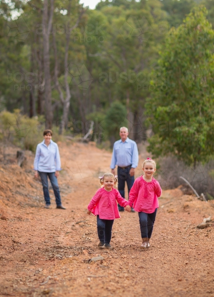 Two little girls and their parents outdoors - Australian Stock Image