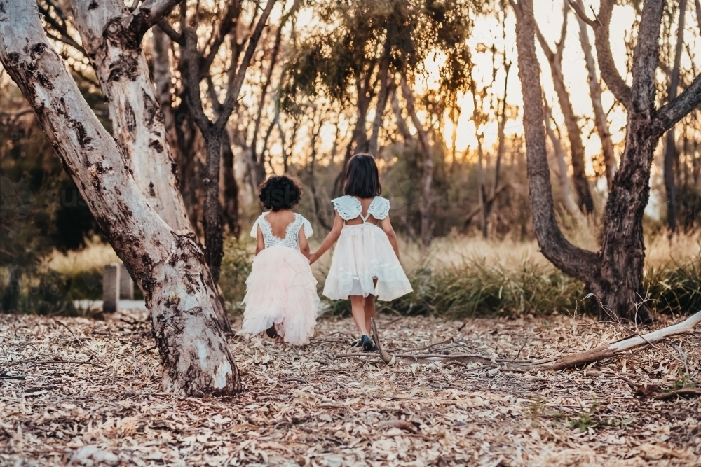 Two little girls walking at the park - Australian Stock Image