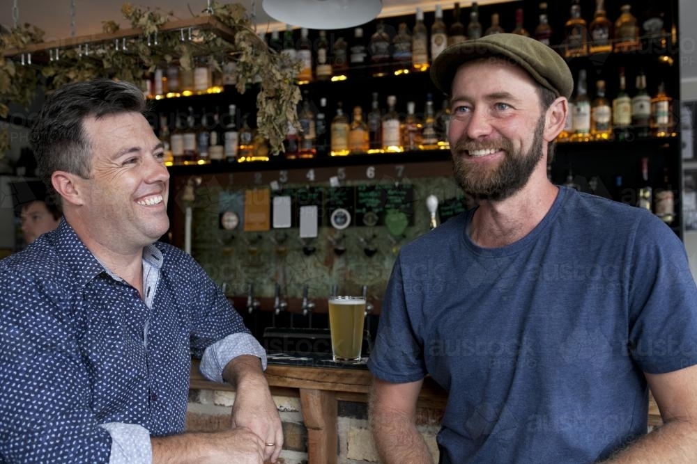 Two mates having a drink at local craft beer pub - Australian Stock Image