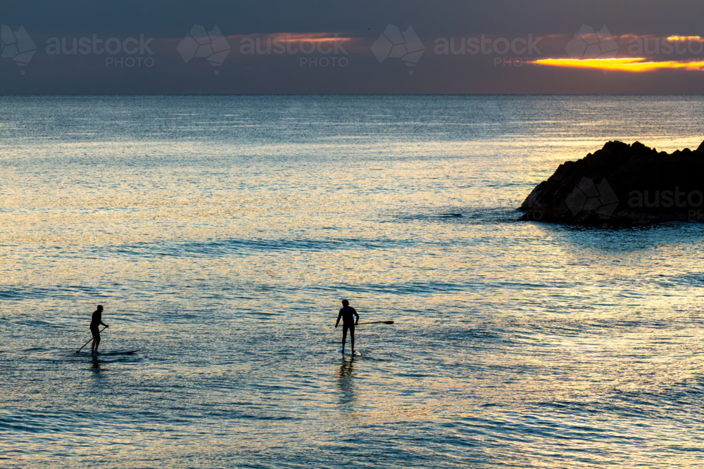 Image of Two mature men paddleboard SUP near Norries Head at Cabarita ...