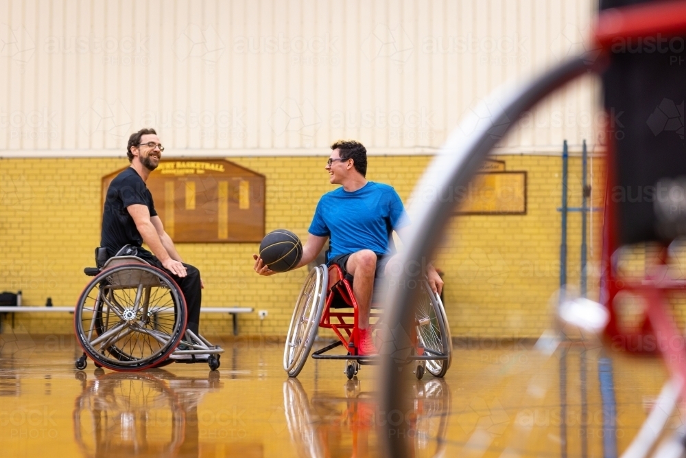 Image of two men having fun in wheelchairs practising wheelchair