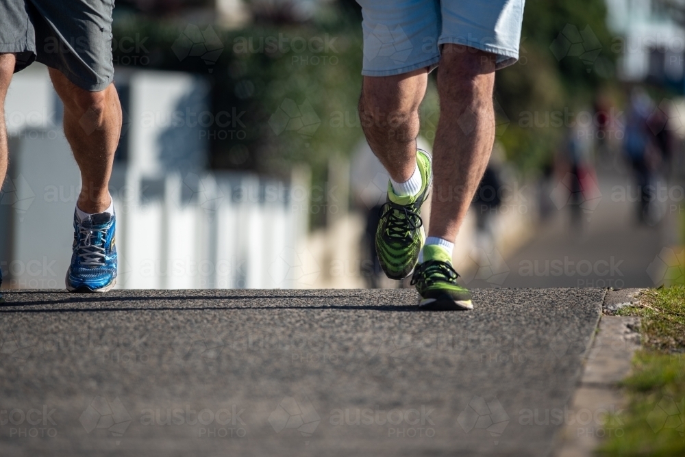 Two men jogging along a busy path - Australian Stock Image