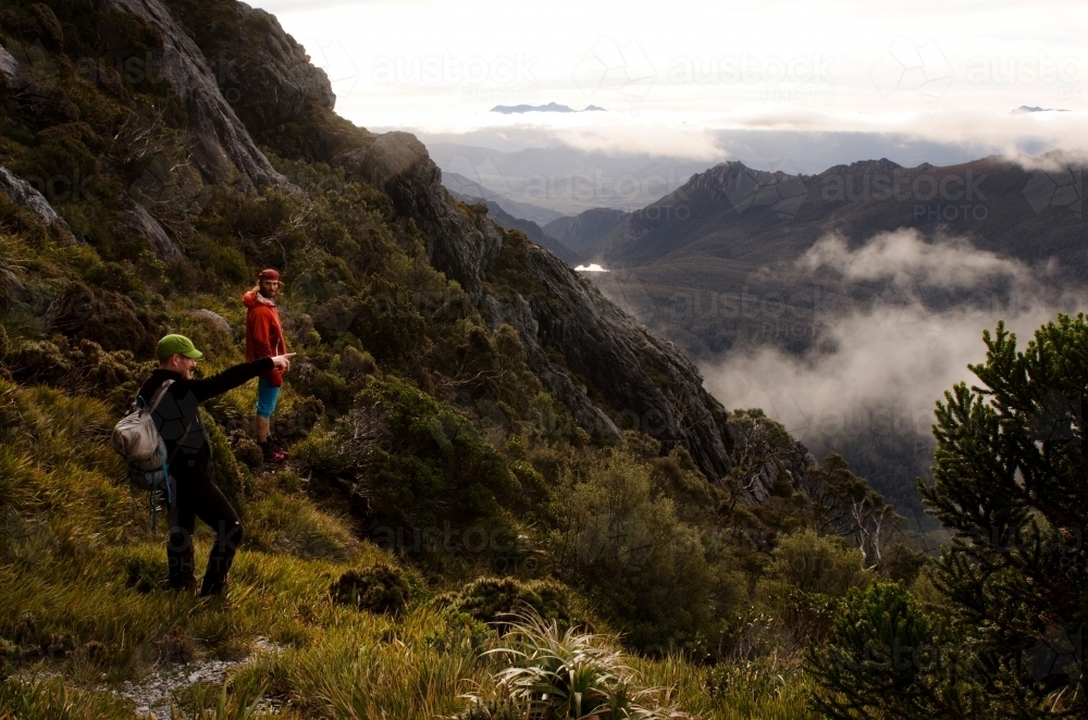 Two men looking out at a mountain range - Australian Stock Image