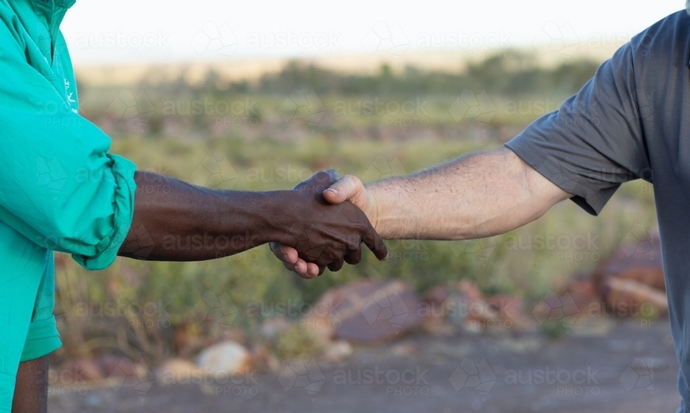 Two men shaking hands in the outback - Australian Stock Image