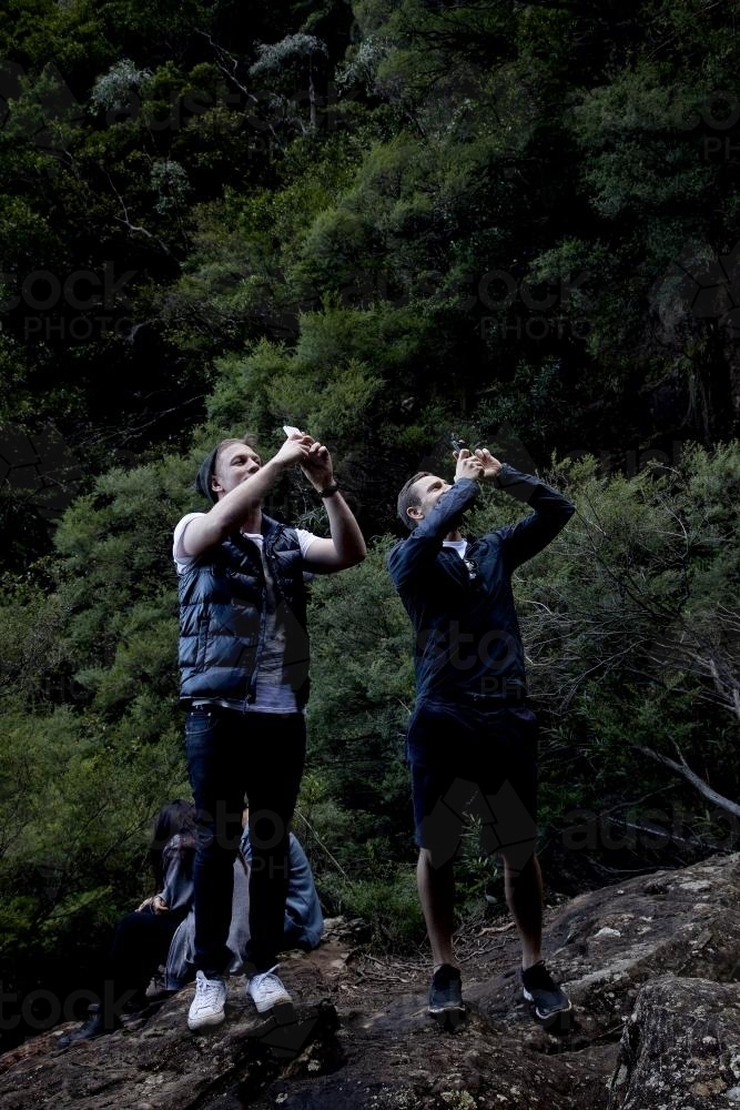 Two men taking photos on bush walk - Australian Stock Image
