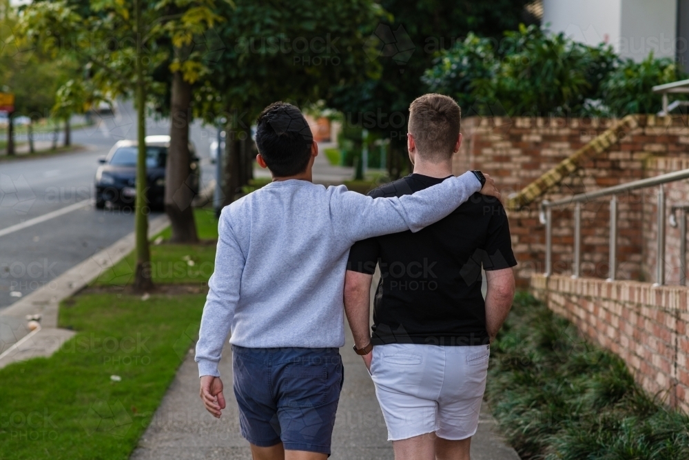 two men walking on the footpath - Australian Stock Image