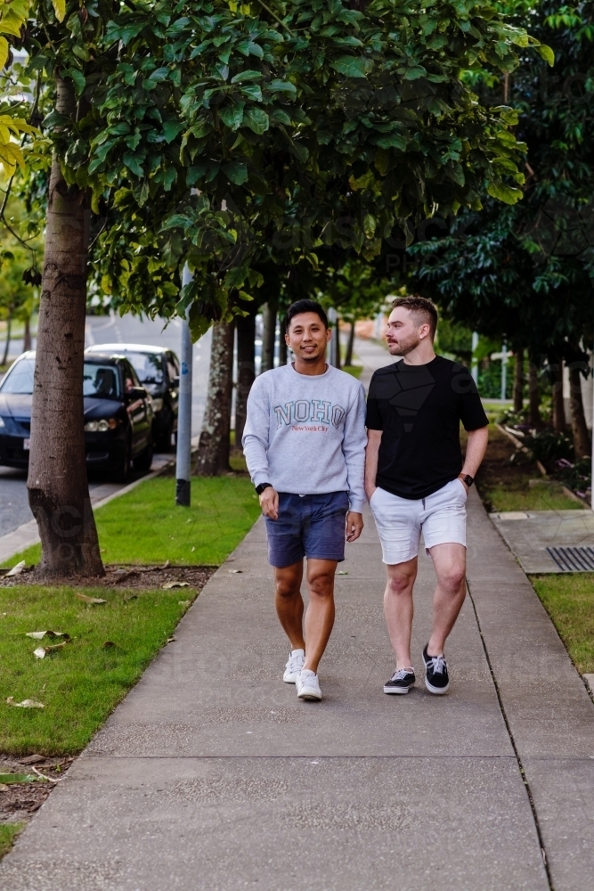 two men walking on the footpath - Australian Stock Image