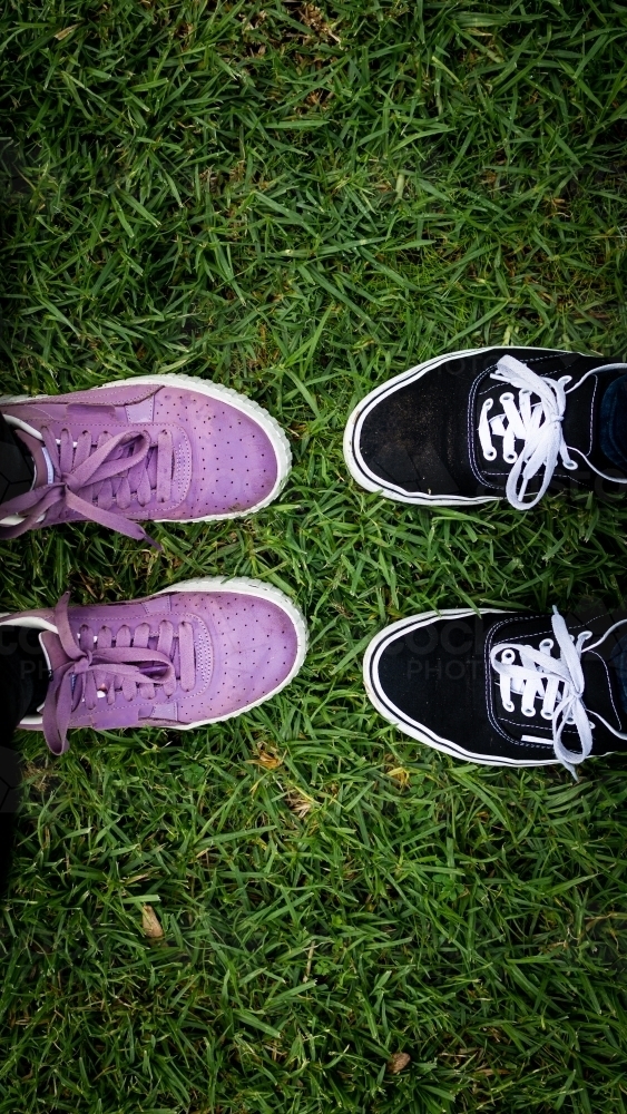 Two Pairs of Shoes Standing Together in Green Grass. - Australian Stock Image