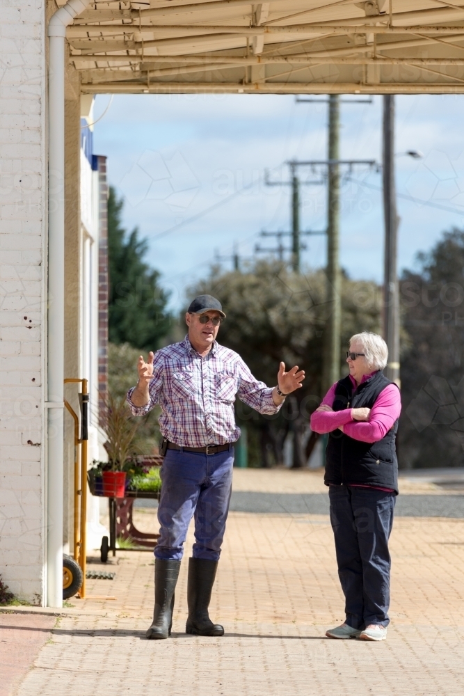 Two people having a conversation in the street - Australian Stock Image