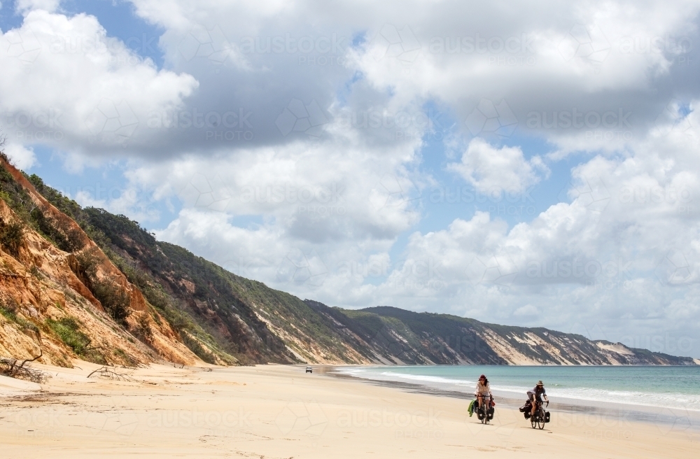 Two people ride on beach - Australian Stock Image