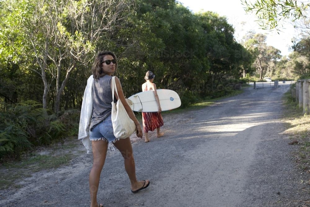Two people walking to the beach - Australian Stock Image