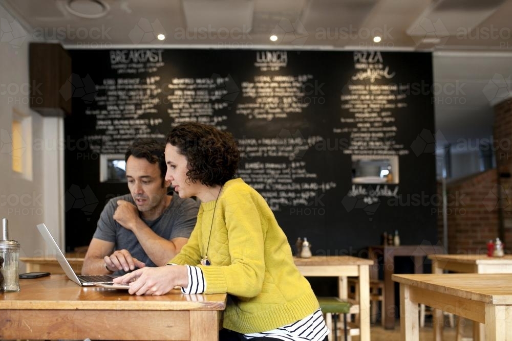 Two people with laptop at a cafe - Australian Stock Image