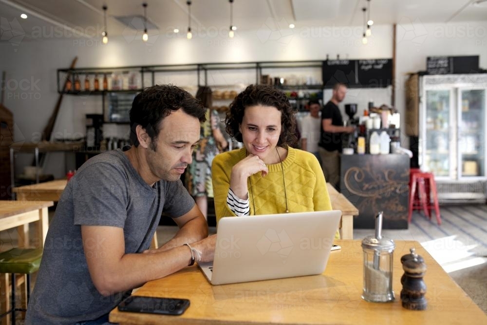 Two people with laptop at a cafe - Australian Stock Image