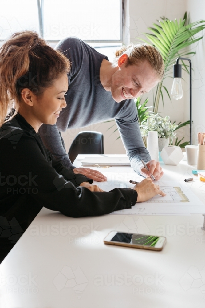 Two people working on a house design together - Australian Stock Image