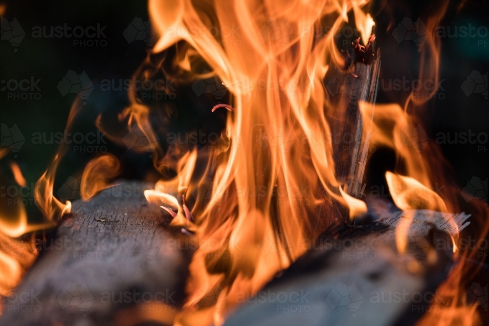Two planks of wood on fire with shallow depth of field - Australian Stock Image