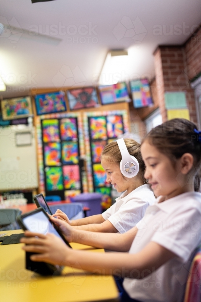 Two Primary School Students in Classroom Learning on iPads - Australian Stock Image
