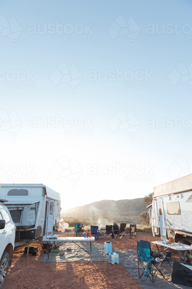 Two recreational vehicles parked on a dry, grassy field at campsite - Australian Stock Image