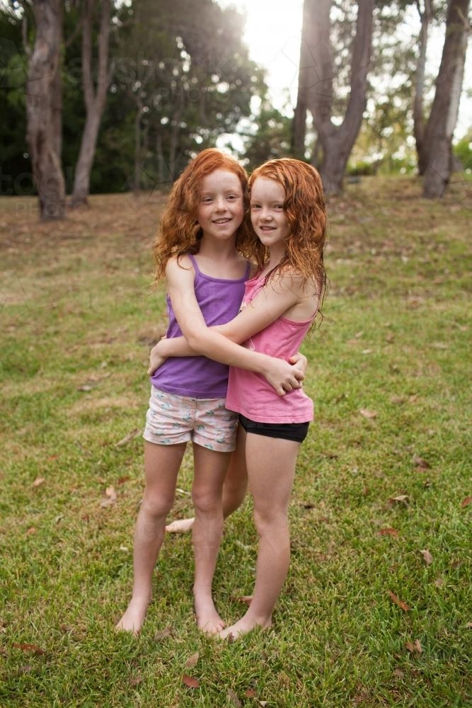 Image Of Two Redhead Girls Hugging In A Field Austockphoto