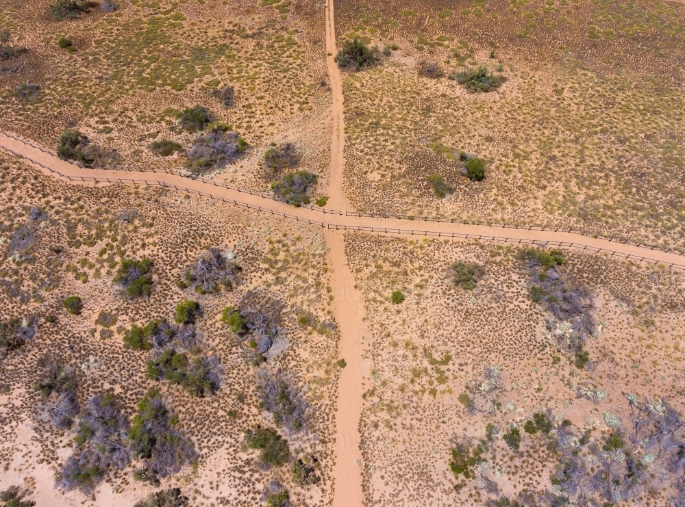 two sandy trails crossing seen from above in arid landscape - Australian Stock Image