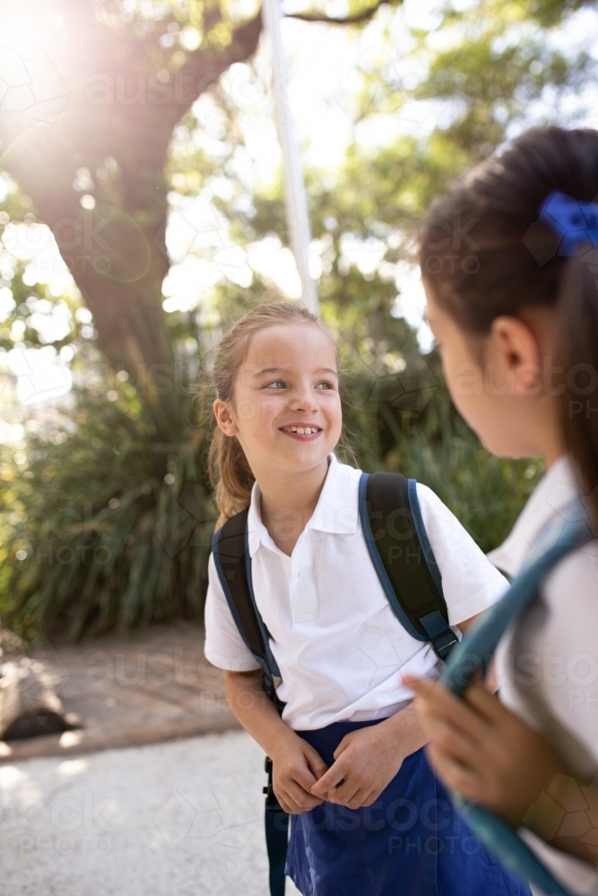 Image of Two Schoolgirls Chatting Outside - Austockphoto