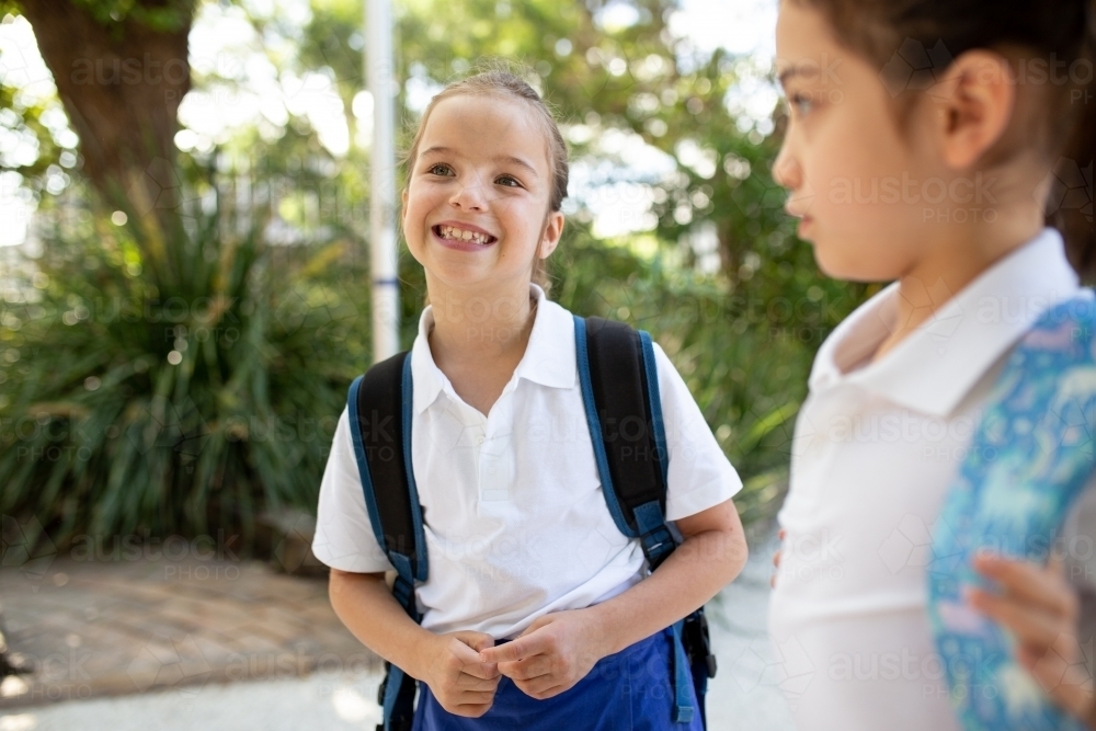 Image of Two Schoolgirls Together in Playground - Austockphoto