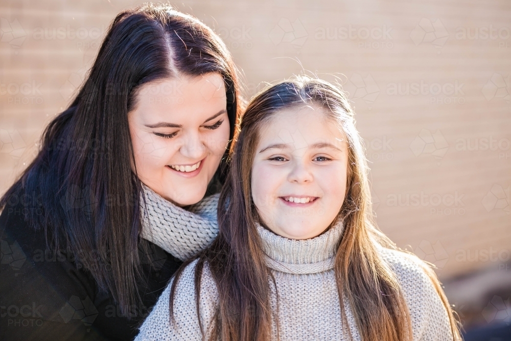 Two sisters laughing together - Australian Stock Image