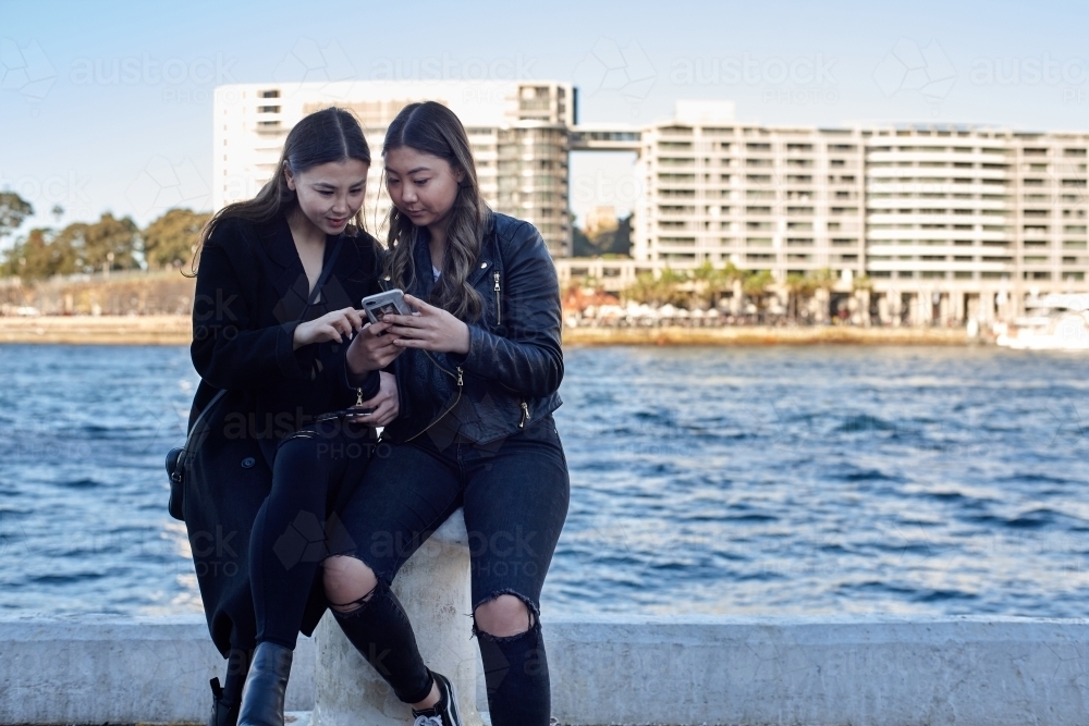 Two sisters spending time together harbourside - Australian Stock Image