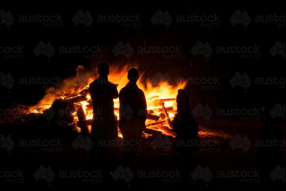 Two teen girls standing by a bonfire - Australian Stock Image