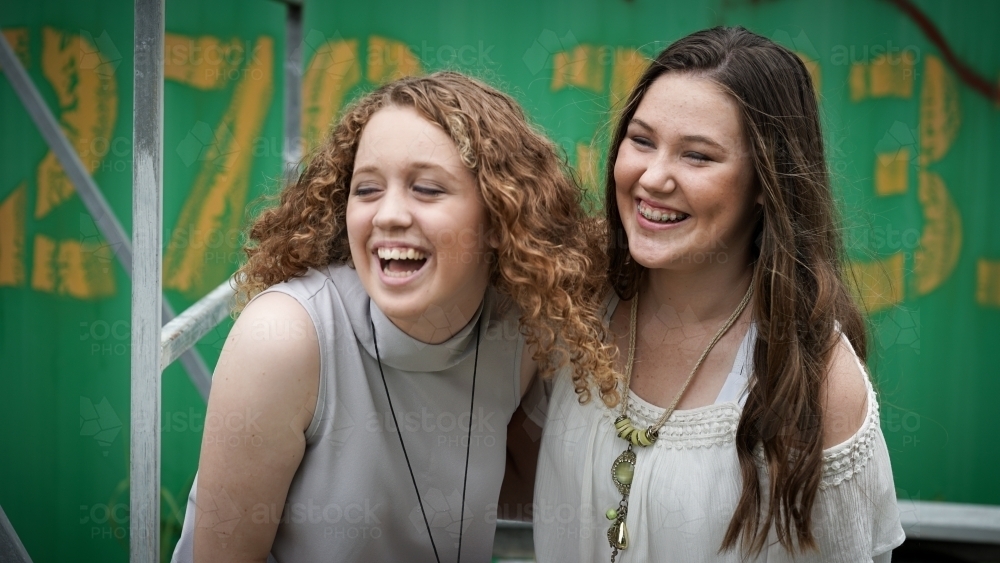 Two teenage girlfriends laughing - Australian Stock Image