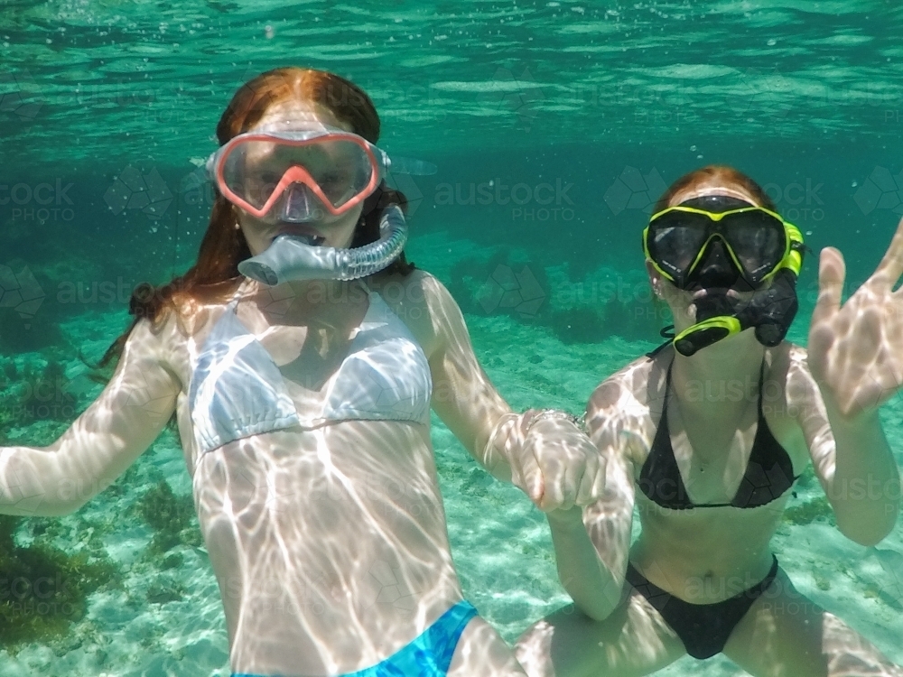 Two teenage girls snorkelling in an ocean rock pool - Australian Stock Image