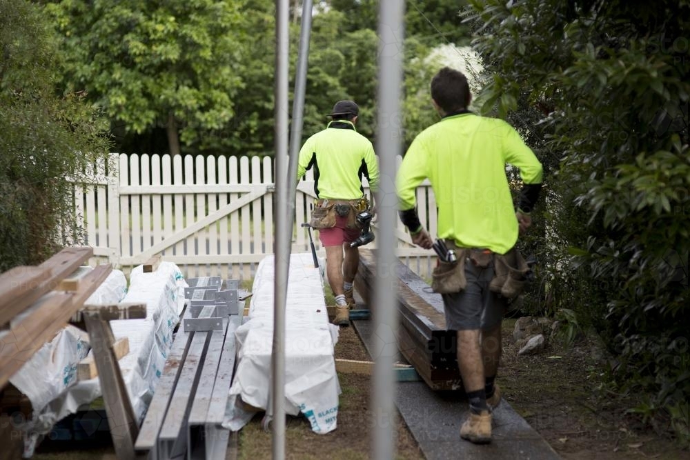 Two tradesmen work on home renovations. - Australian Stock Image