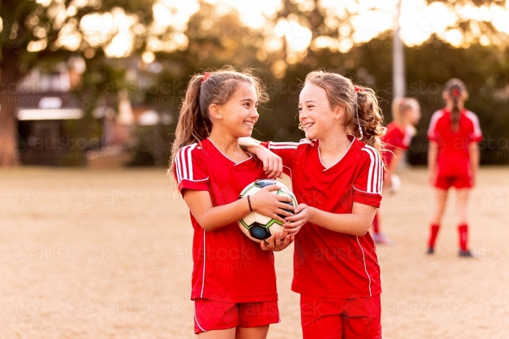 Two tween football players standing together at a sports oval - Australian Stock Image