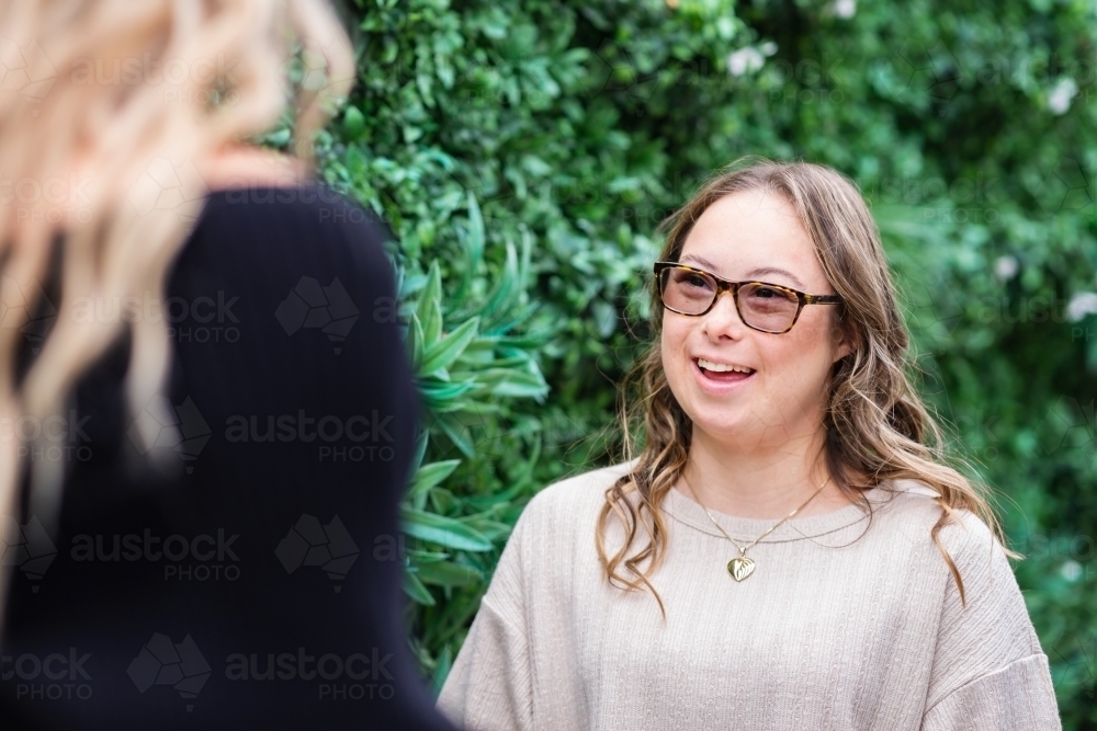two woman talking, from a series featuring a young woman with Down Syndrome - Australian Stock Image