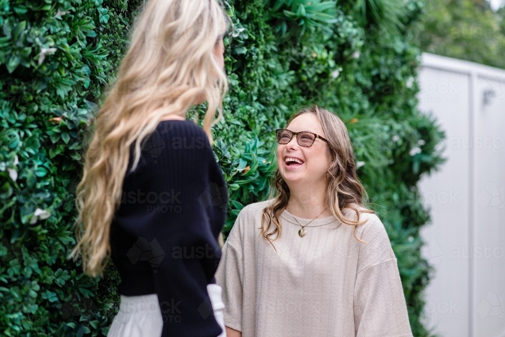 two woman talking, from a series featuring a young woman with Down Syndrome - Australian Stock Image