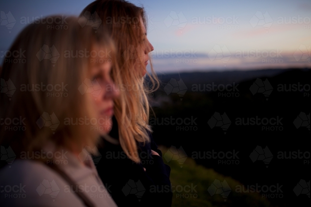 Two women at a lookout at dusk - Australian Stock Image