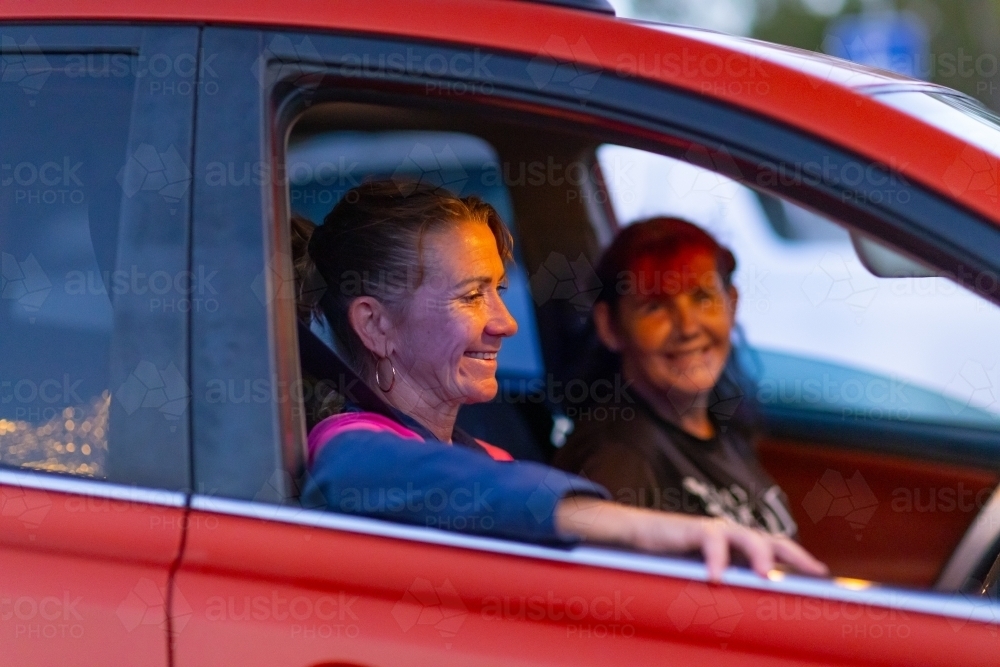 two women sitting in a parked car in a happy mood - Australian Stock Image