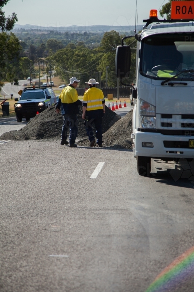 Two workers about to begin resurfacing road work - Australian Stock Image