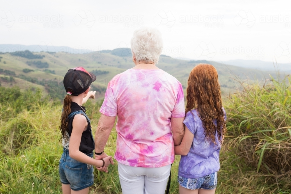 Two young girls and an elderly lady looking at a view - Australian Stock Image