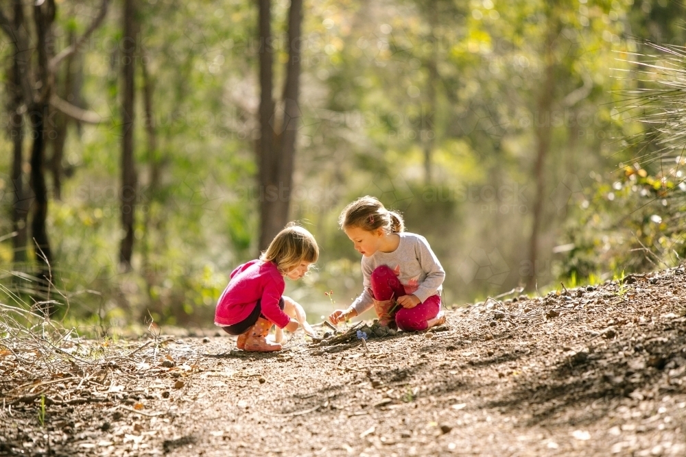 Two young girls play in the bush - Australian Stock Image