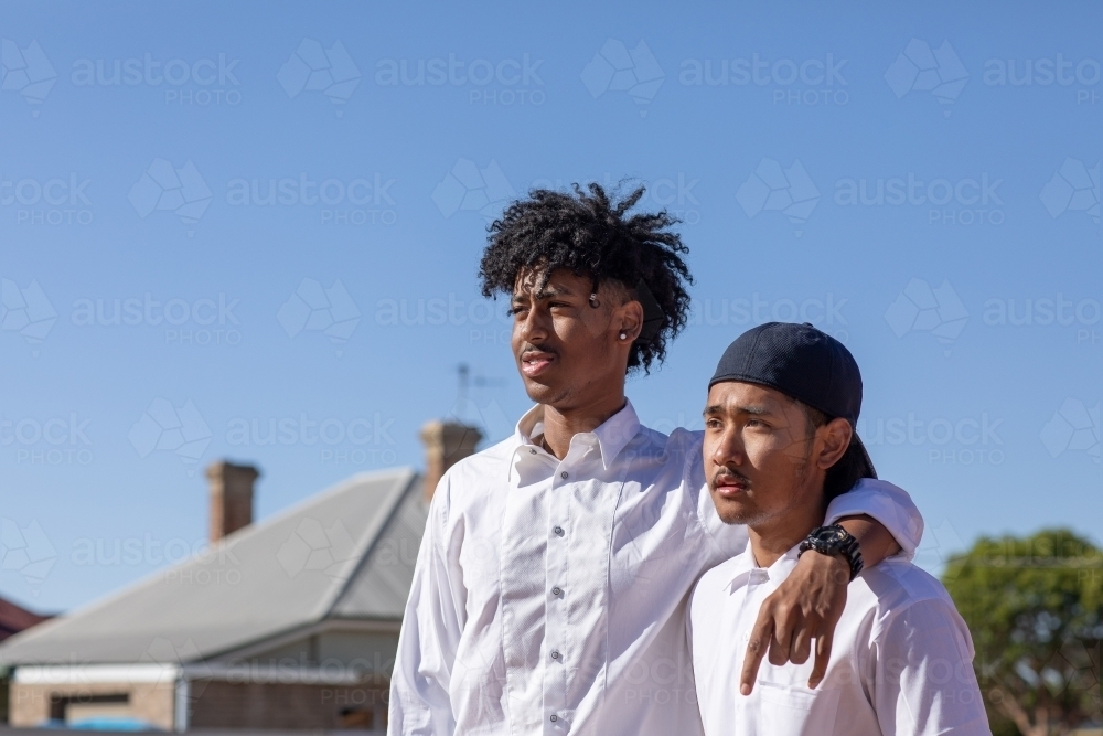 two young guys in white shirts - Australian Stock Image