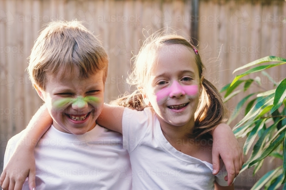 Two young kids with zinc on their noses, boy and girl - Australian Stock Image