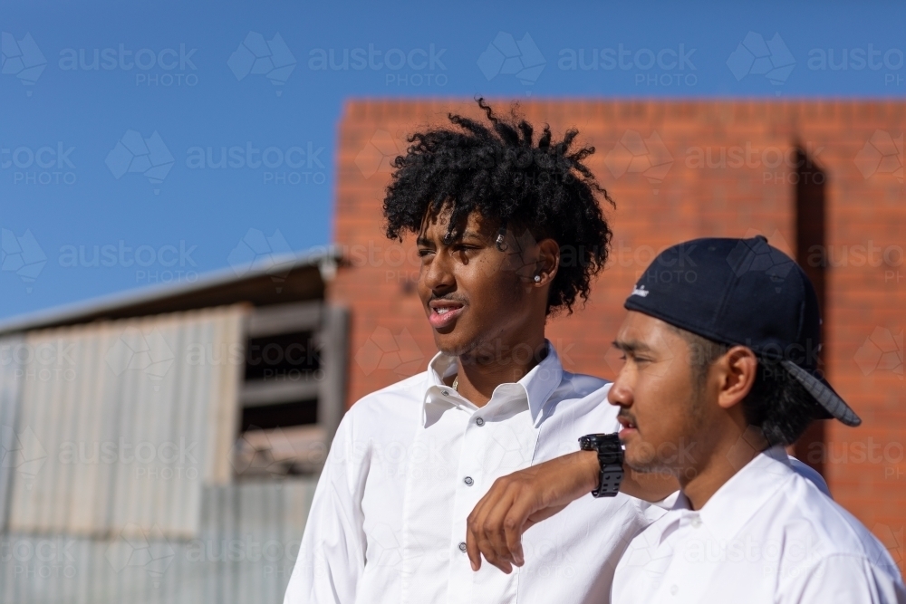two young mates in white shirts - Australian Stock Image