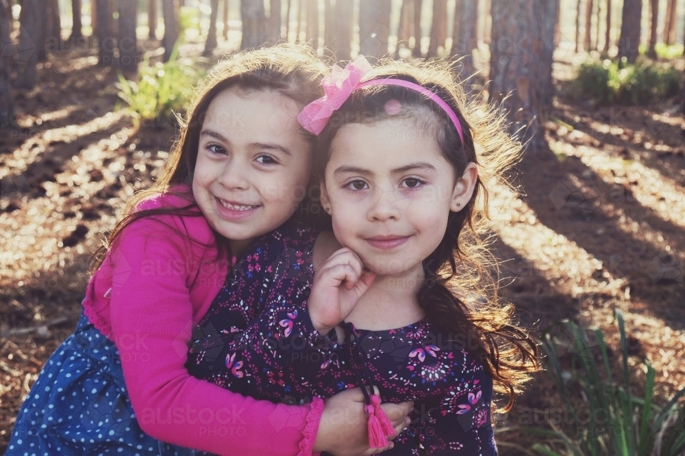 Two young multicultural girls in the wood : Austockphoto Two young multicultural girls in the wood - Australian Stock Image