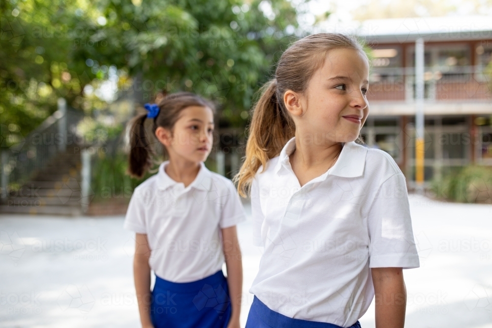 Image of Two Young Schoolgirls Outside - Austockphoto