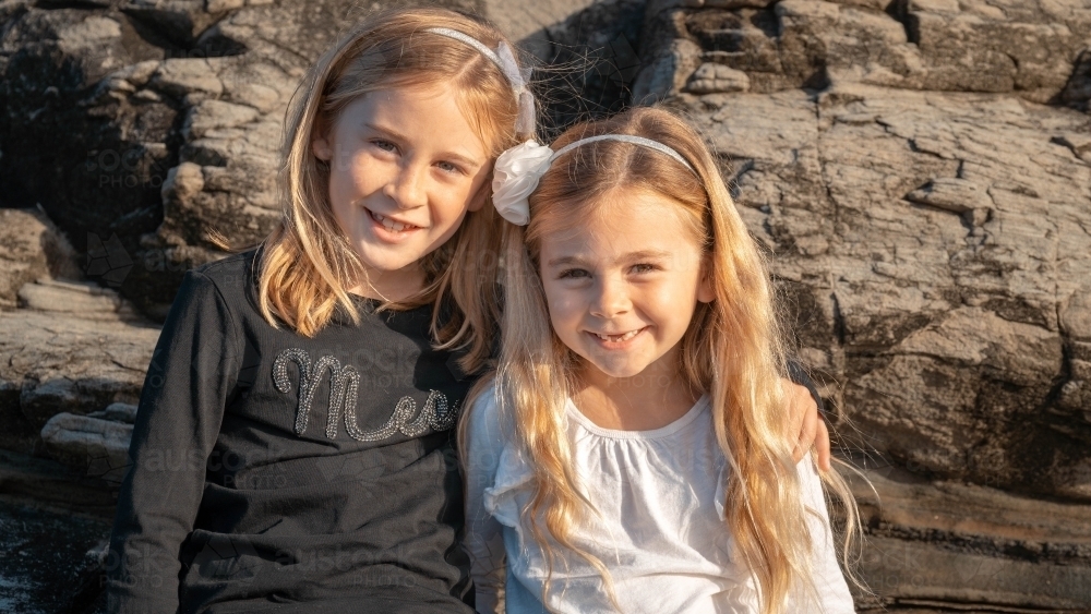 Two young sisters portrait at the beach - Australian Stock Image