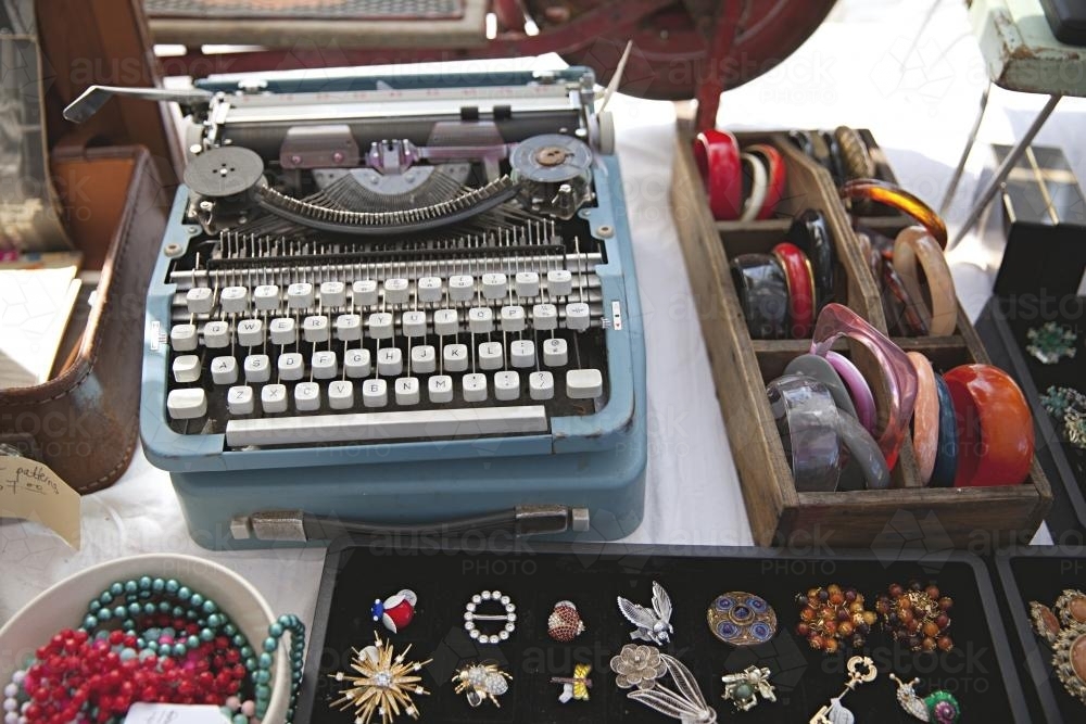 Typewriter and jewellery for sale at a flea market - Australian Stock Image