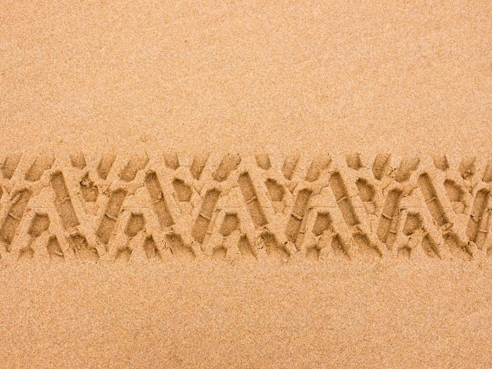 Tyre tread pattern in beach sand - Australian Stock Image